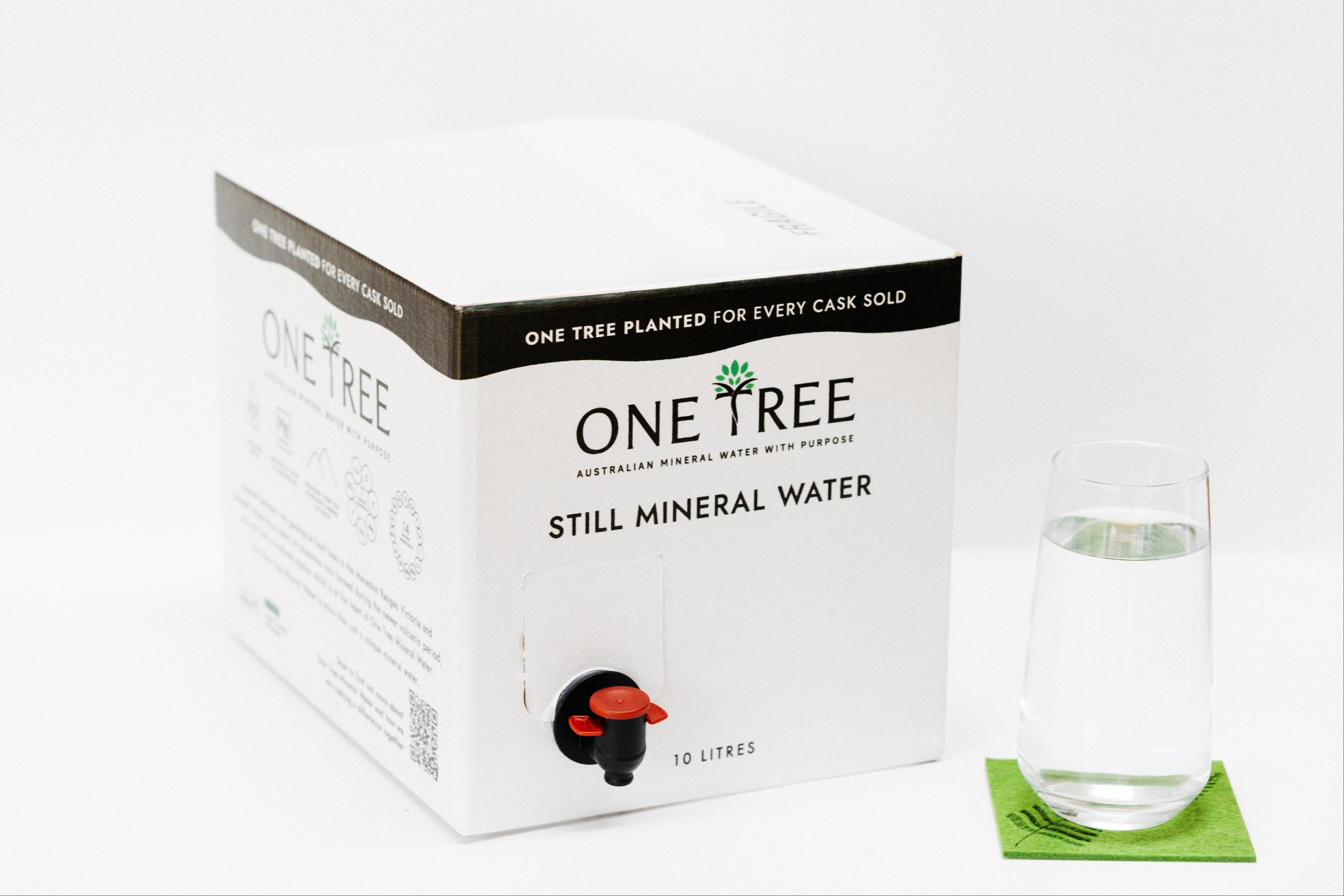 One Tree Mineral Water 10L cask with a glass of water in a clean white lifestyle setting